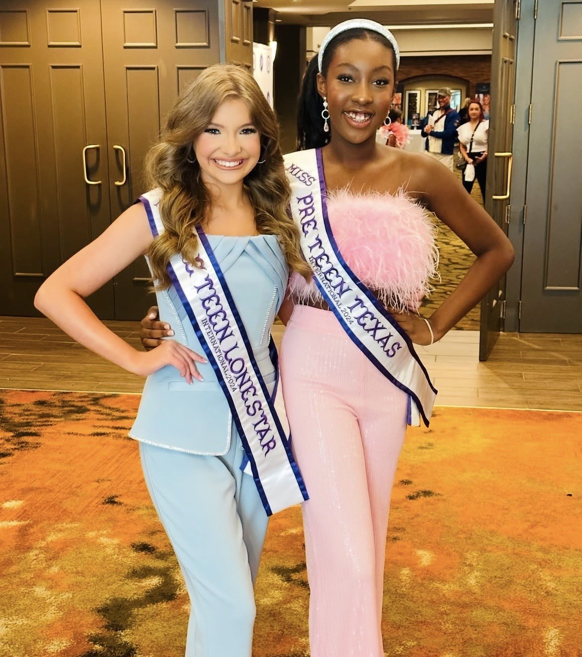 Two Pre Teen titleholders smiling together in their sashes